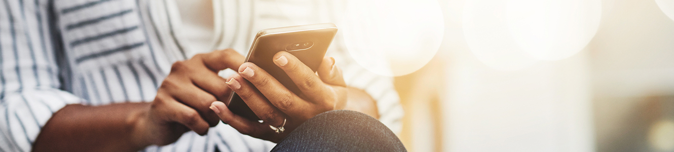 Woman holding her smart phone in her hands.